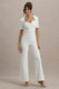 Simone | Weißer Jumpsuit mit Sweetheart-Ausschnitt, kurzen Ärmeln und weitem Bein