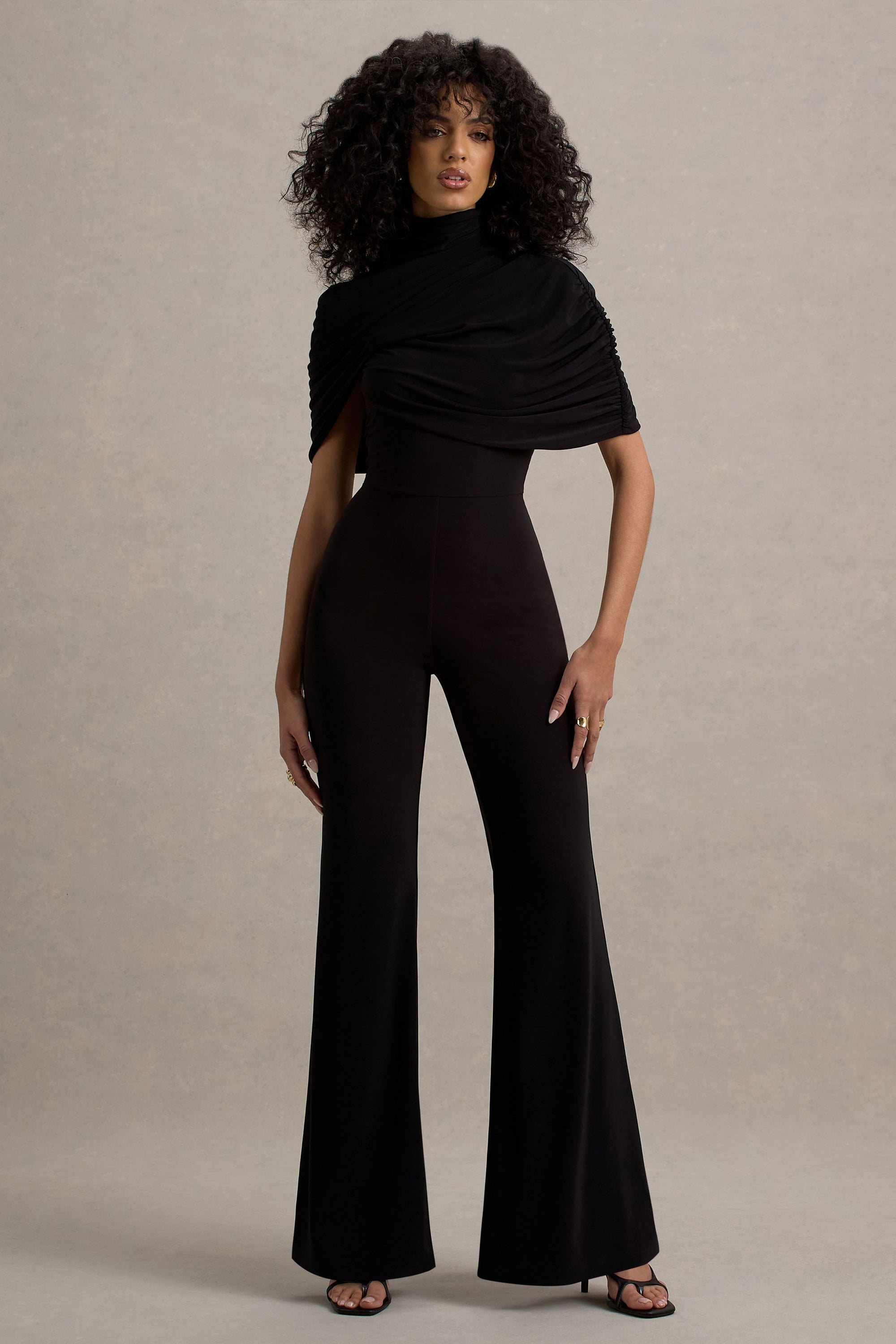 Isoline | Schwarzer Twist-Cape-Jumpsuit mit ausgestelltem Bein